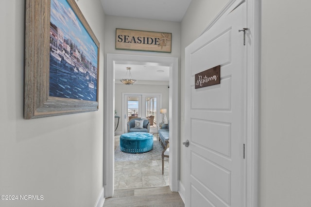 hallway featuring a notable chandelier