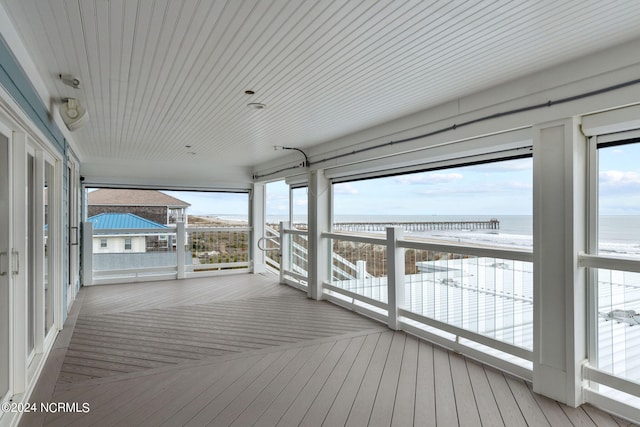 deck featuring a water view and a beach view