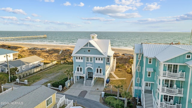 drone / aerial view featuring a water view and a beach view