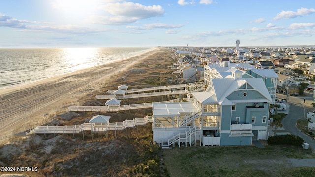 drone / aerial view with a water view and a beach view