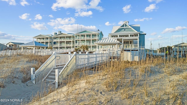 view of dock featuring a water view and a gazebo