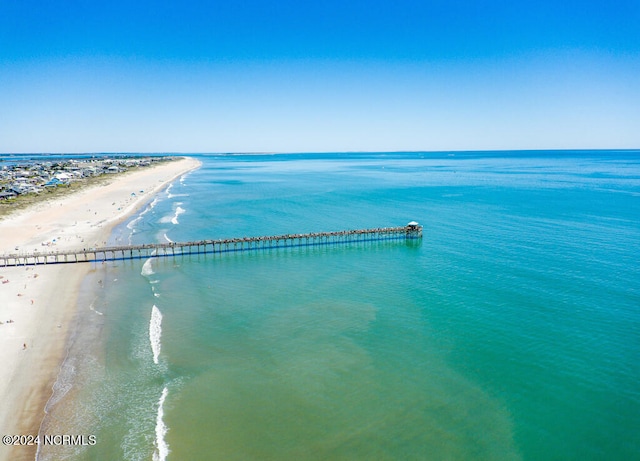 birds eye view of property featuring a beach view and a water view