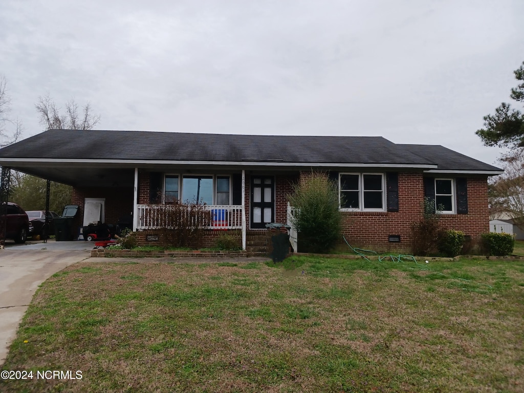 single story home with a front lawn, a carport, and a porch