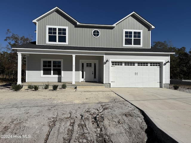 view of front facade featuring covered porch and a garage