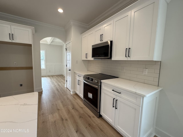 kitchen featuring white cabinetry, light stone countertops, and stainless steel appliances