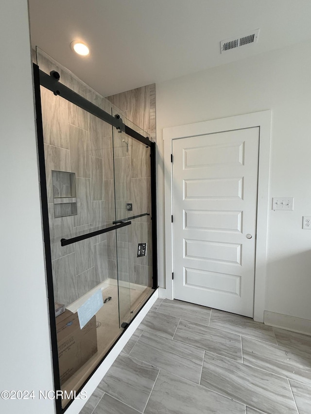 bathroom featuring an enclosed shower