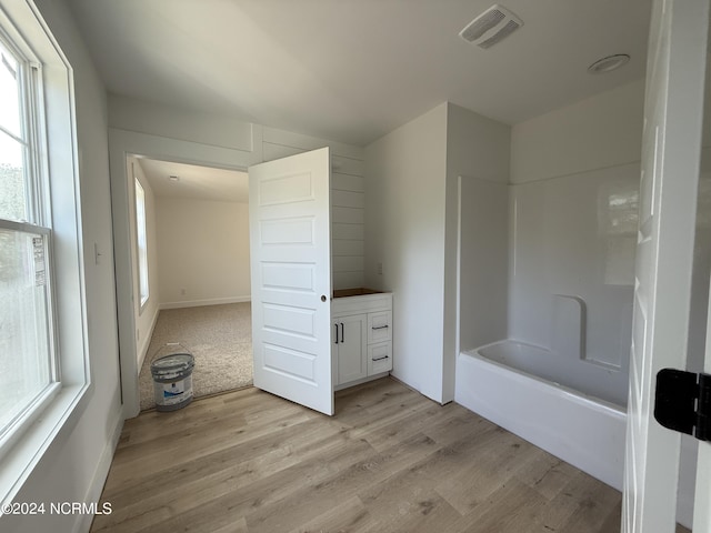 bathroom with vanity, hardwood / wood-style floors, and  shower combination