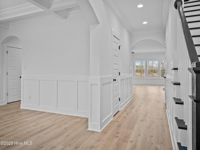 corridor featuring coffered ceiling, ornamental molding, beam ceiling, and light hardwood / wood-style flooring