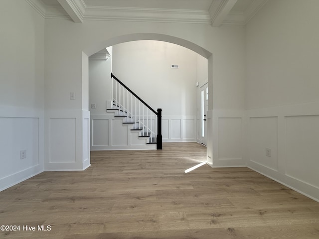 foyer entrance featuring light hardwood / wood-style floors and crown molding