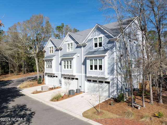 view of front facade with central AC unit and a garage