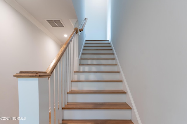 staircase featuring ornamental molding