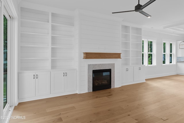 unfurnished living room featuring light hardwood / wood-style flooring, ceiling fan, and ornamental molding