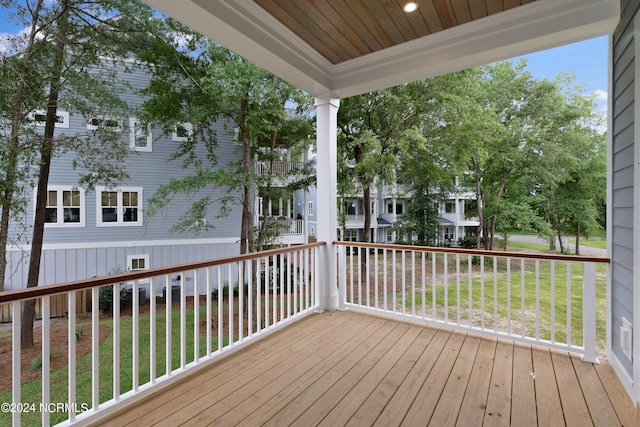 wooden deck with a lawn