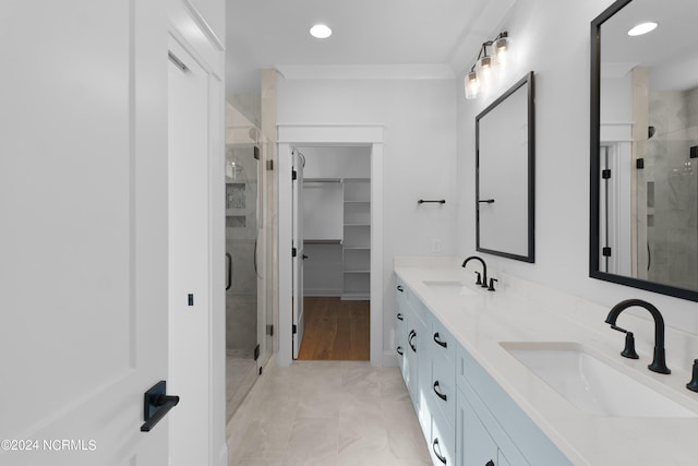 bathroom featuring vanity and an enclosed shower