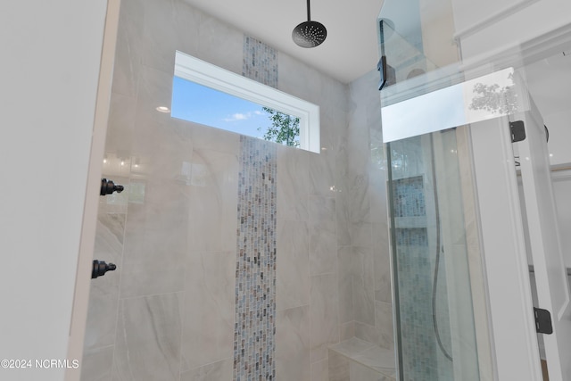 bathroom with tiled shower