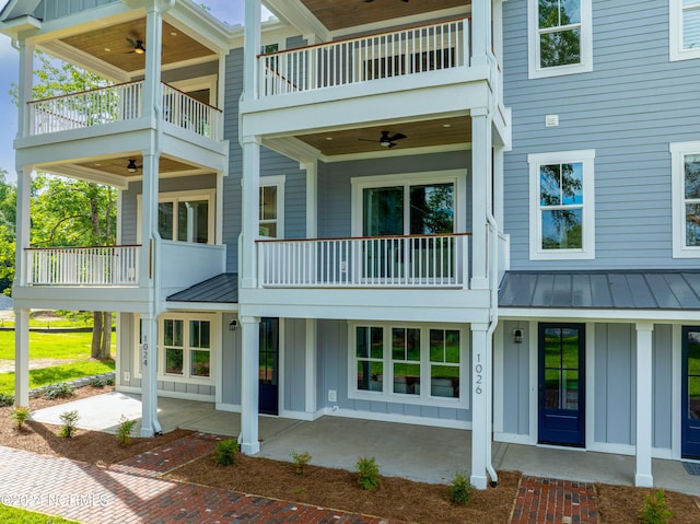 rear view of property with a balcony and ceiling fan