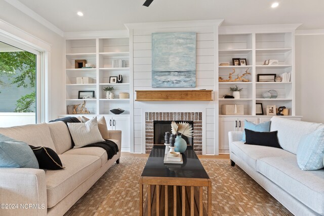 living room featuring built in shelves and a fireplace