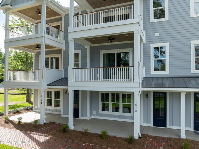 rear view of house featuring a patio, ceiling fan, and a balcony