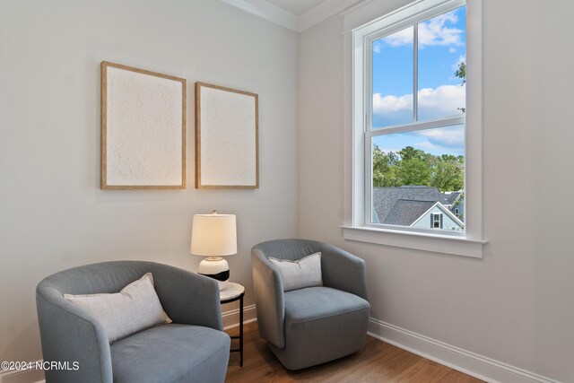 sitting room featuring crown molding and hardwood / wood-style floors