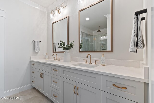 bathroom featuring double vanity, an enclosed shower, ornamental molding, and tile floors