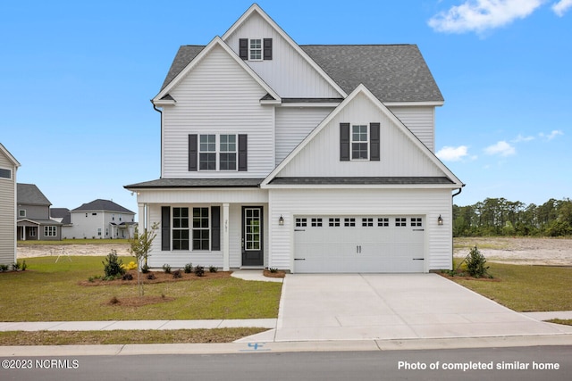 view of front of house with a front yard and a garage