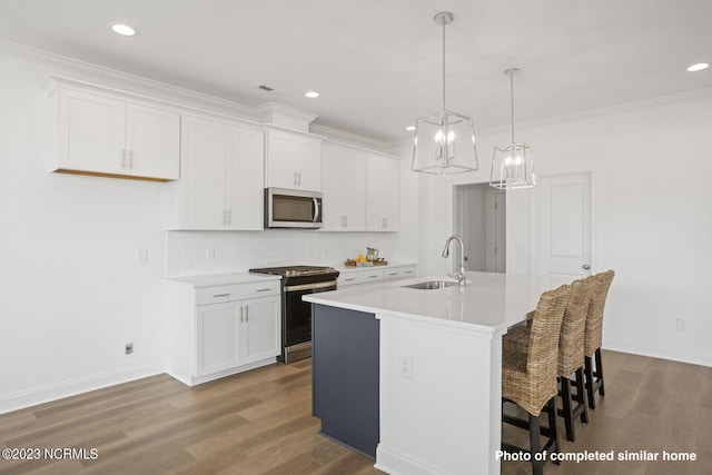 kitchen with dark wood-style flooring, a fireplace, light countertops, stainless steel dishwasher, and a sink