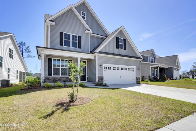 craftsman house with board and batten siding, stone siding, and concrete driveway