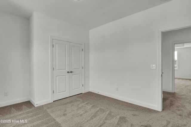 carpeted spare room with baseboards