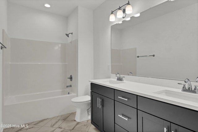 bathroom featuring double vanity, a sink, shower / bathing tub combination, and toilet