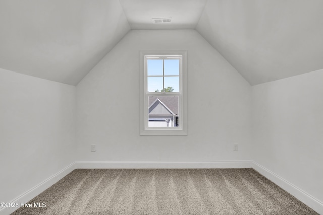 bonus room featuring baseboards, carpet, lofted ceiling, and visible vents
