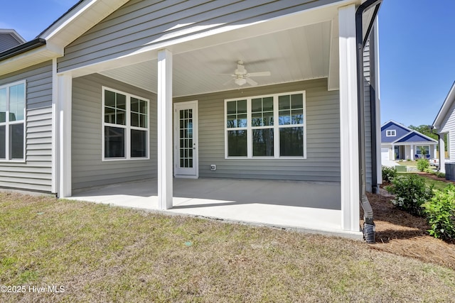 rear view of house featuring a lawn, a ceiling fan, and a patio area