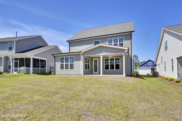 rear view of property featuring a yard and central AC
