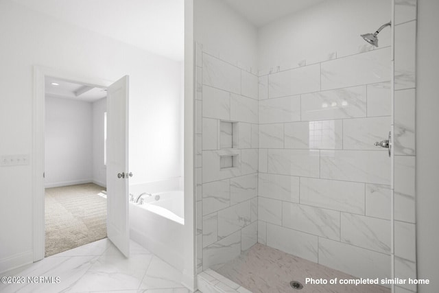 bathroom with a garden tub and tiled shower