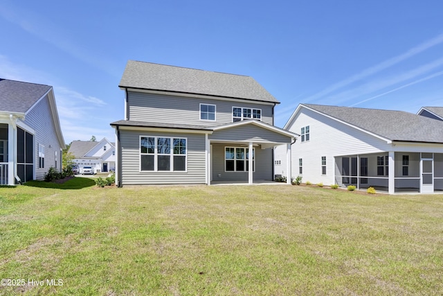rear view of house featuring a lawn