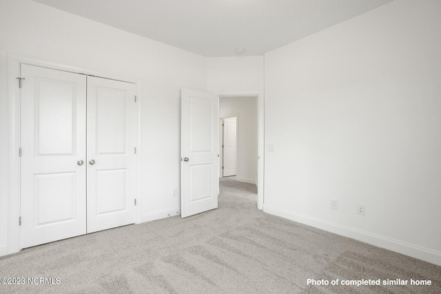 unfurnished bedroom featuring a closet, carpet flooring, and baseboards