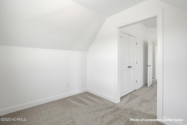 bonus room featuring carpet, vaulted ceiling, and baseboards