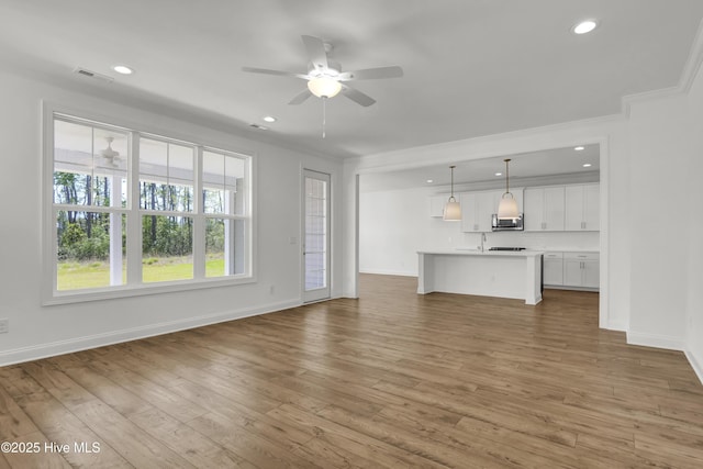 unfurnished living room featuring recessed lighting, ceiling fan, and baseboards