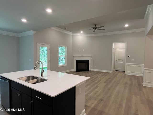 1114 Natal Dr SE, Bolivia, NC 28422 - kitchen with a sink, crown molding, light countertops, dark cabinets, and light wood-type flooring