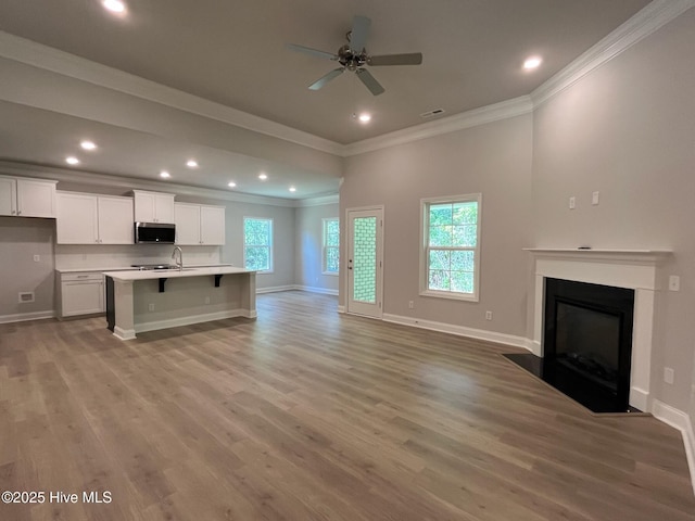 1114 Natal Dr SE, Bolivia, NC 28422 - unfurnished living room with ornamental molding, a ceiling fan, light wood-style flooring, recessed lighting, and baseboards