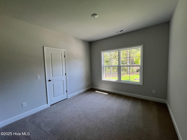 1114 Natal Dr SE, Bolivia, NC 28422 - spare room featuring dark carpet and baseboards
