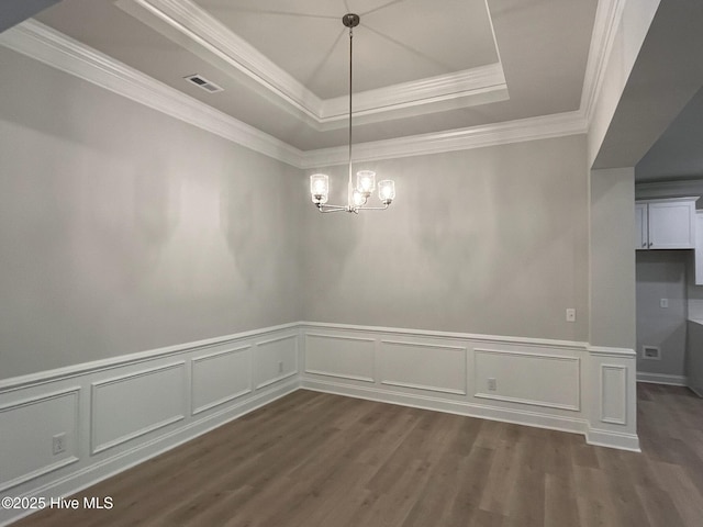 1114 Natal Dr SE, Bolivia, NC 28422 - unfurnished dining area featuring a raised ceiling, dark wood-type flooring, a chandelier, ornamental molding, and a decorative wall