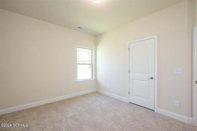 unfurnished room with baseboards, carpet flooring, and visible vents