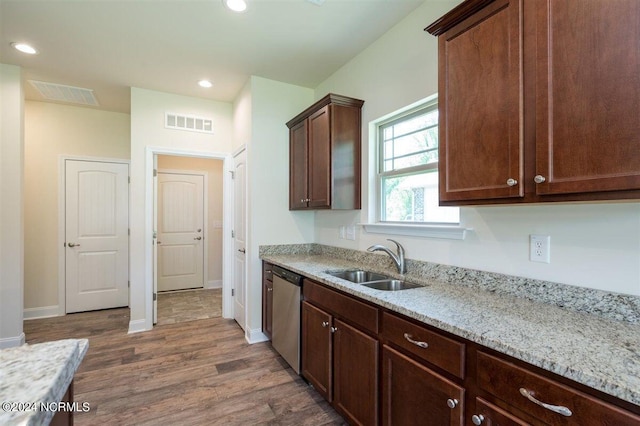 kitchen featuring light stone counters, dark wood-type flooring, sink, dark brown cabinets, and dishwasher