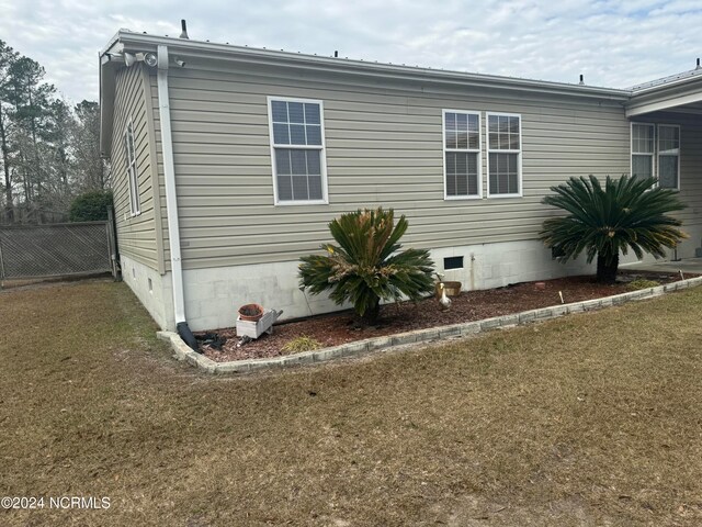 view of side of home featuring a lawn