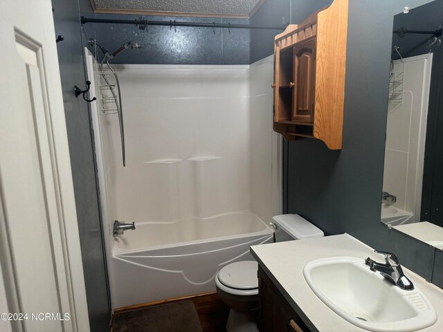 full bathroom featuring hardwood / wood-style floors, shower / tub combination, a textured ceiling, toilet, and oversized vanity