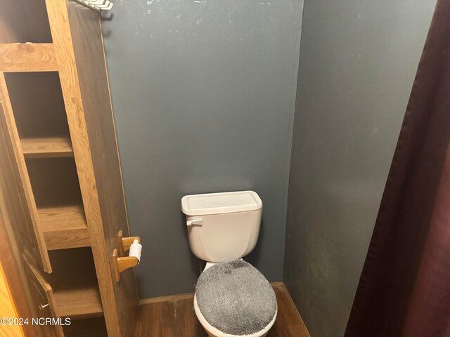 bathroom with toilet and wood-type flooring