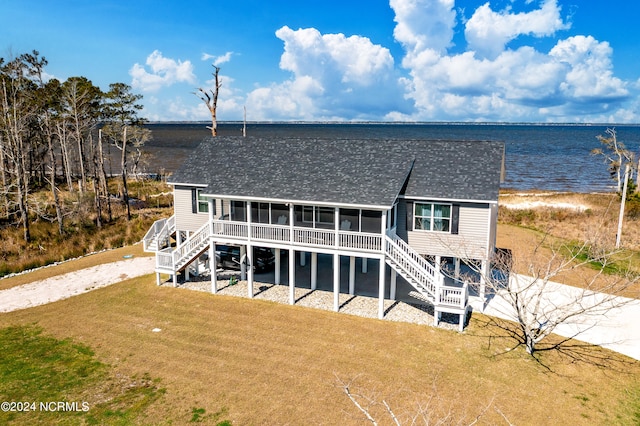 view of front of home with a water view and a front yard