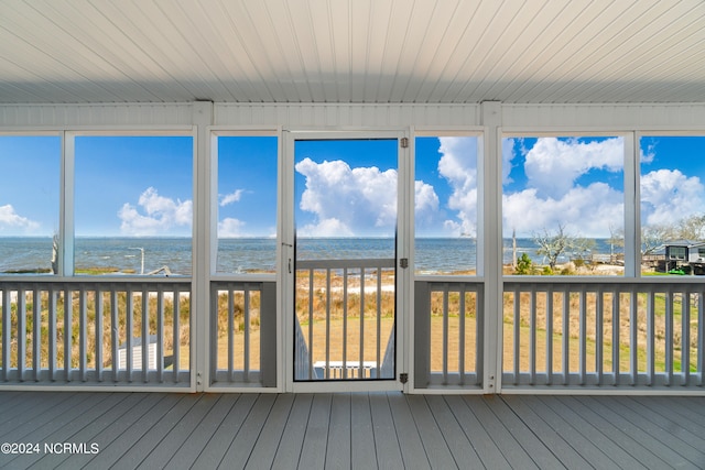 unfurnished sunroom with a water view and wood ceiling