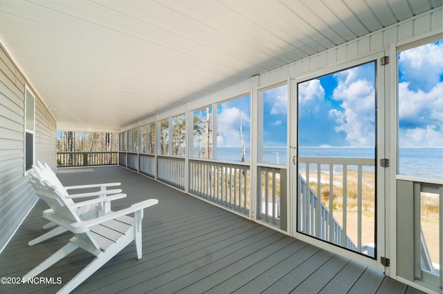 unfurnished sunroom with a water view and plenty of natural light