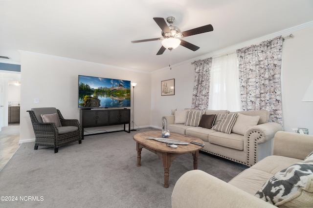 living room with ornamental molding, carpet floors, and ceiling fan